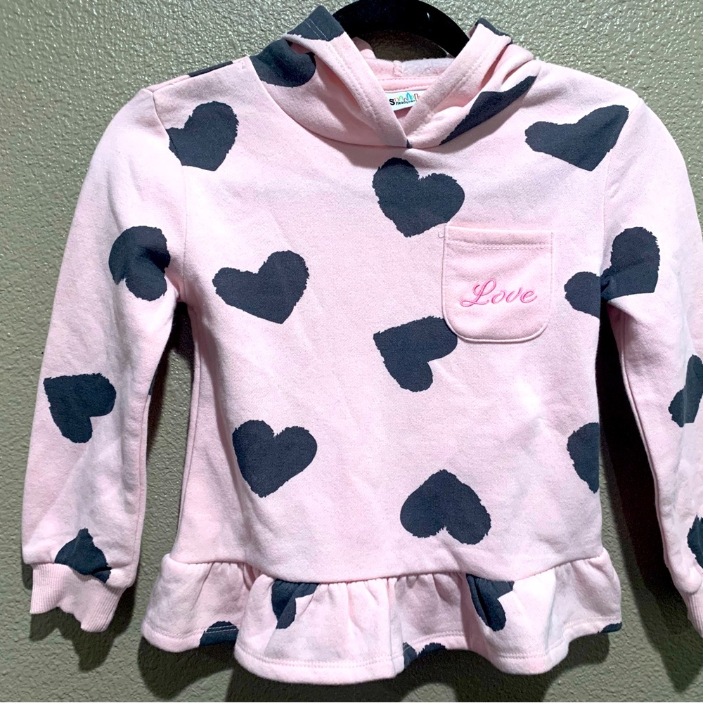 pink sweater with black hearts